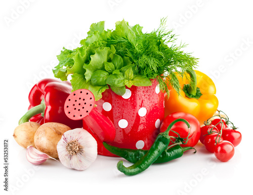 Photo: fresh vegetables with green herbs in watering can fresh vegetables with green herbs in watering can