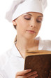 woman cook reading recipes book, isolated on white
