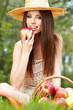 Photo: Apple woman. Very beautiful ethnic model eating red apple in the Apple woman. Very beautiful ethnic model eating red apple in the