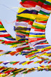 Buddhist Tibetan prayer flags against blue sky background