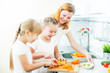 Happy mother and daughters cooking