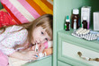 sick girl lying on a bed