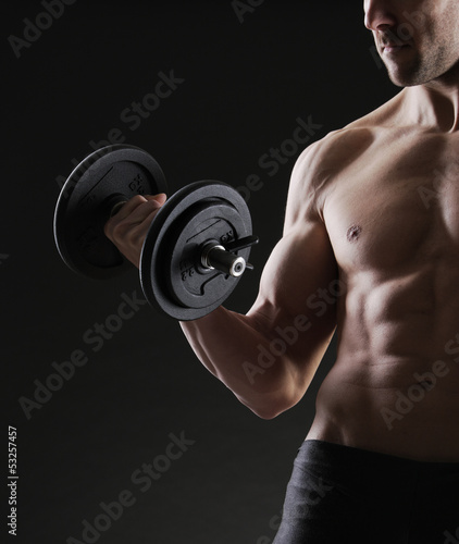 Photo: Exercising biceps with dumbbells Exercising biceps with dumbbells