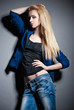Foto: Posing blond woman with long hair on grey Posing blond woman with long hair on grey