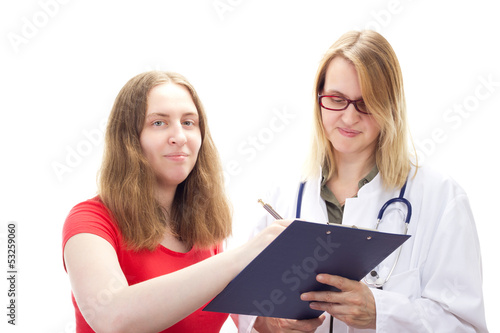 Photo: Young female patient signing agreement Young female patient signing agreement