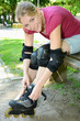 Junge Frau zieht Inlineskates an