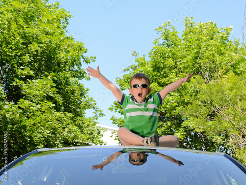 Photo: Boy on the roof of car Boy on the roof of car