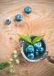 Blueberries in an old metal ladle and leafs
