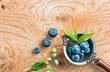 Blueberries in an old metal ladle and leafs