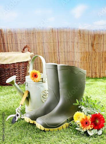 Photo: Gardener tools and equipment on a green lawn Gardener tools and equipment on a green lawn