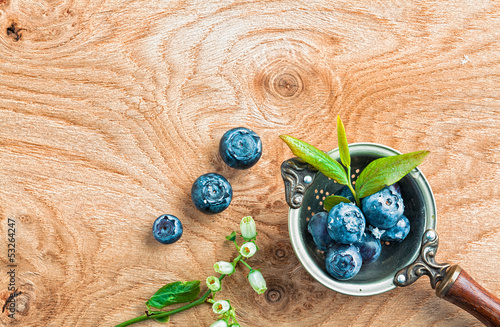 Photo: Blueberries in an old metal ladle and leafs Blueberries in an old metal ladle and leafs