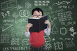 Asian boy student read book in class