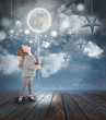 Photo: Child Playing with Moon and Stars at Night Child Playing with Moon and Stars at Night