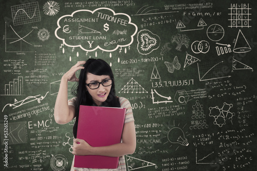 Photo: Asian female student upset about assignment in class Asian female student upset about assignment in class