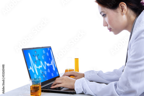 Photo: Attractive scientist with laptop on white Attractive scientist with laptop on white