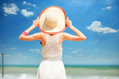 Photo: Redhead girl on the beach in spring time. Redhead girl on the beach in spring time.