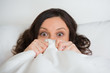 Girl hides her face in bed