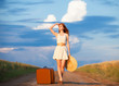 Redhead girl with suitcase at outdoor.