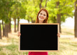 Redhead girl with blackboard at outdoor