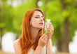 Redhead girl with perfume at outdoor