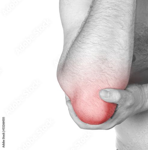 Photo: Acute pain in a man elbow. Male holding hand to spot of elbow pa Acute pain in a man elbow. Male holding hand to spot of elbow pa