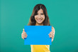 Photo: Holding a blue paper Holding a blue paper