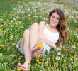 Young woman enjoying the spring between dandelions