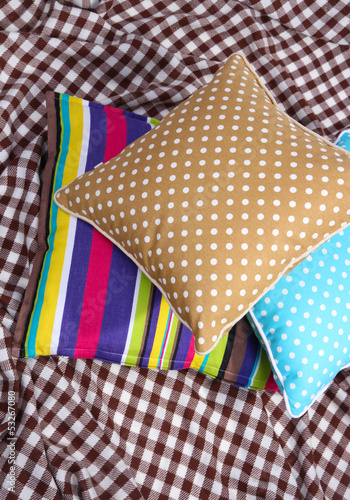 Photo: Three various pillows on plaid Three various pillows on plaid