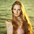 Beautiful redhead girl at pond