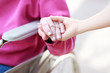 Foto: Senior Lady in Wheelchair Holding Hands Senior Lady in Wheelchair Holding Hands