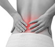 Pain in woman back. Female holding hands on spot pain back isola