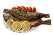 Fried trout with tomatoes and lemon isolated on white background