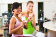 Photo: women in the gym drinking protein shake women in the gym drinking protein shake