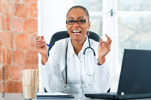 Photo: Portrait of young female doctor in clinic Portrait of young female doctor in clinic