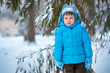 Cute little boy playing outdoors in a forest