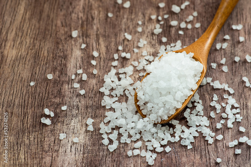 Photo: Sea salt over wooden background Sea salt over wooden background