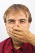 man covers his face with his hand