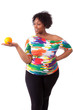 Photo: Overweight young black woman holding an orange - African people Overweight young black woman holding an orange - African people