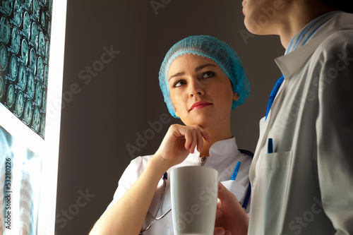 Photo: Two doctors examining x-ray results Two doctors examining x-ray results