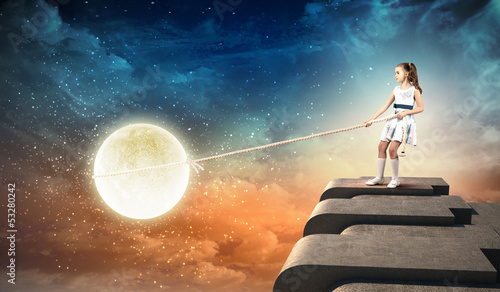 Photo: Little girl pulling moon Little girl pulling moon