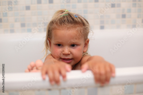 Photo: Little girl playing in the bath tub Little girl playing in the bath tub
