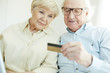 Photo: Senior couple with card Senior couple with card