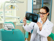 A dentist holding an x-ray