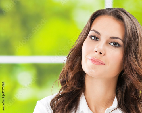Photo: Young smiling cheerful businesswoman at office Young smiling cheerful businesswoman at office