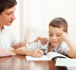 Photo: Father helping son do homework Father helping son do homework