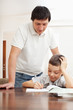 Photo: Father helping son do homework Father helping son do homework