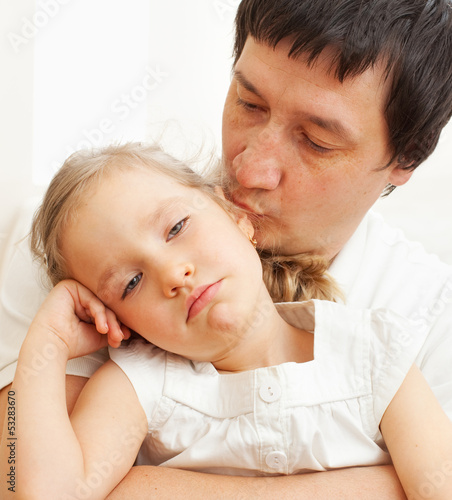 Photo: Father comforts a sad girl Father comforts a sad girl