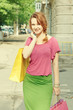 Girl with papper bags at street