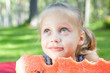 Foto: Funny child with watermelon in the park Funny child with watermelon in the park