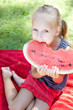 Foto: Funny child with watermelon in the park Funny child with watermelon in the park